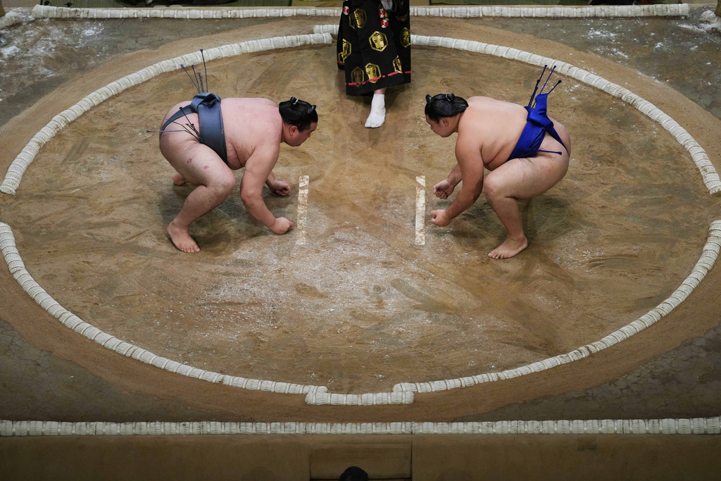 Sumo rikishi Kinbozan and Oshoma, right, during their Grand Sumo Tournament bout on the dohyo, the sacred sumo wrestling ring, at the Royal Albert Hall in London, Sunday, Oct. 19, 2025.(AP Photo/Frank Augstein)