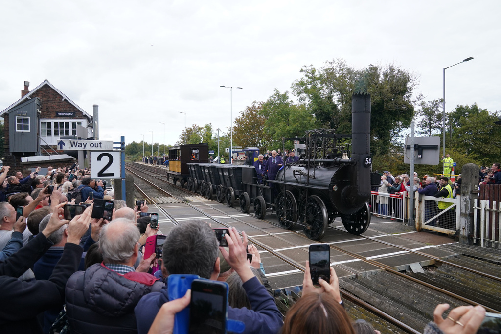 Replica Locomotion No1 passes through Heighington, County Durham, Friday, Sept. 26, 2025, on its first official journey in 200 years from the Locomotion Museum in Shildon to Darlington, as part of celebrations marking the 200th anniversary of British passenger rail services. (Owen Humphreys/PA via AP)