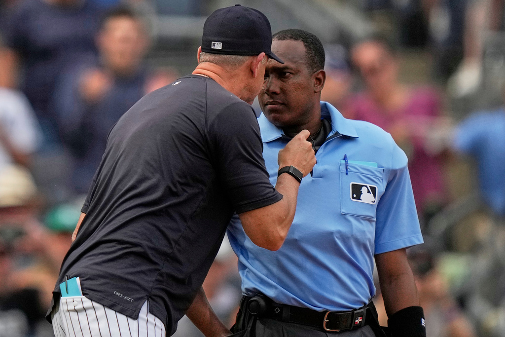Home plate umpire Ramon de Jesus listens to New York Yankees manager Aaron Boone argue a call during the fifth inning of a baseball game against the Baltimore Orioles Saturday, Sept. 27, 2025, in New York. (AP Photo/Frank Franklin II)