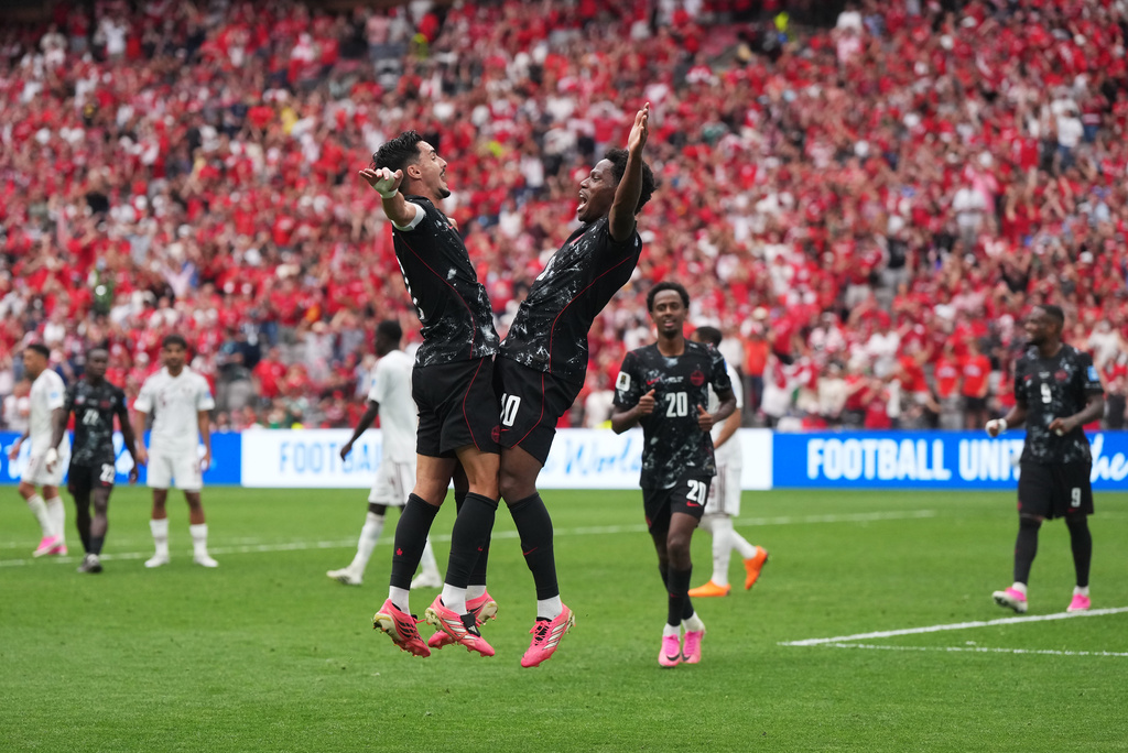 Canada's Jonathan David, front right, celebrates with Stephen Eustaquio,left, after scoring a goal during World Cup Group B soccer match between Canada and Qatar in Vancouver, British Columbia, Thursday, June 18, 2026. (Darryl Dyck/The Canadian Press via AP)