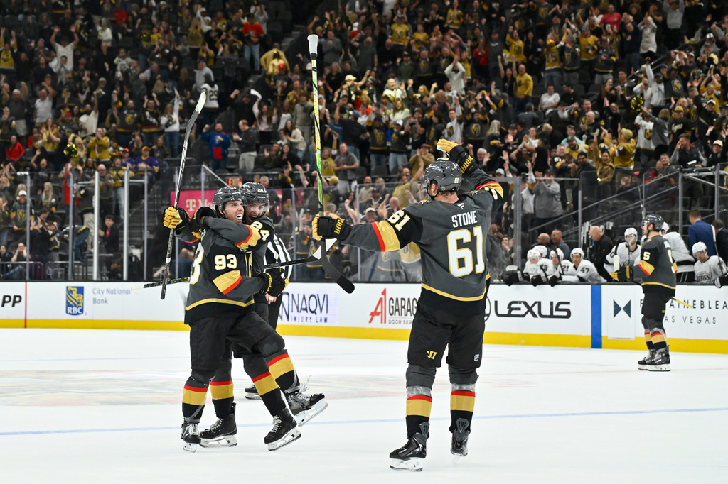 Vegas Golden Knights right wing Mitch Marner (93), left wing Trevor Connelly (24) and right wing Mark Stone (61) celebrate Marner's overtime goal against the Los Angeles Kings in an NHL hockey game Saturday, Oct. 10, 2026, in Las Vegas. (AP Photo/David Becker)