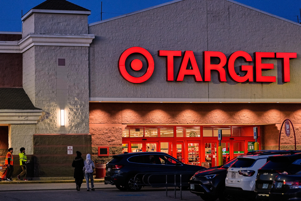 Shoppers walk towards a Target retail store, Tuesday, Nov. 18, 2025, in Salem, N.H. (AP Photo/Charles Krupa)
