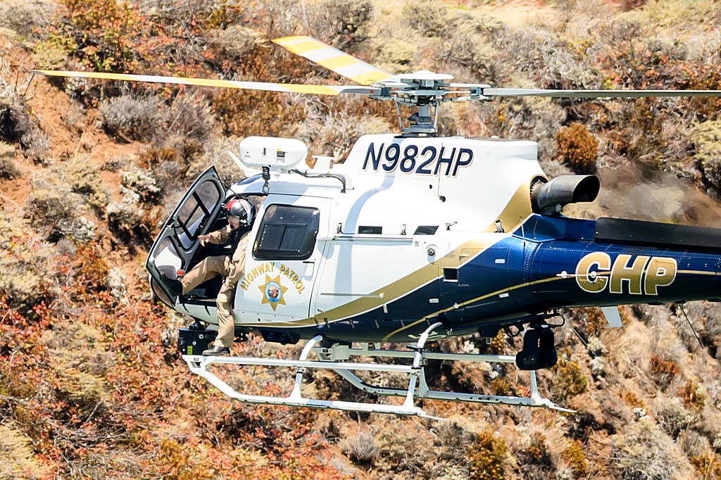 A California Highway Patrol helicopter flies along the Sausalito, Calif. shoreline as search and rescue operations continue for victims of a Tuesday boat sinking on Wednesday, July 15, 2026. (AP Photo/Noah Berger)