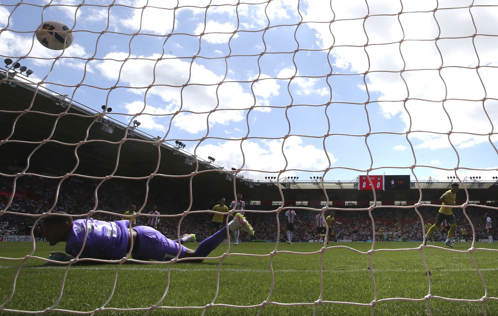 Wrexham's Josh Windass scores his side's first goal of the game from the penalty spot past Southampton goalkeeper Gavin Bazunu during their English Football League Championship soccer match, at St Mary's Stadium, Southampton, England, Saturday, Aug. 9, 2025. (Steven Paston/PA via AP)