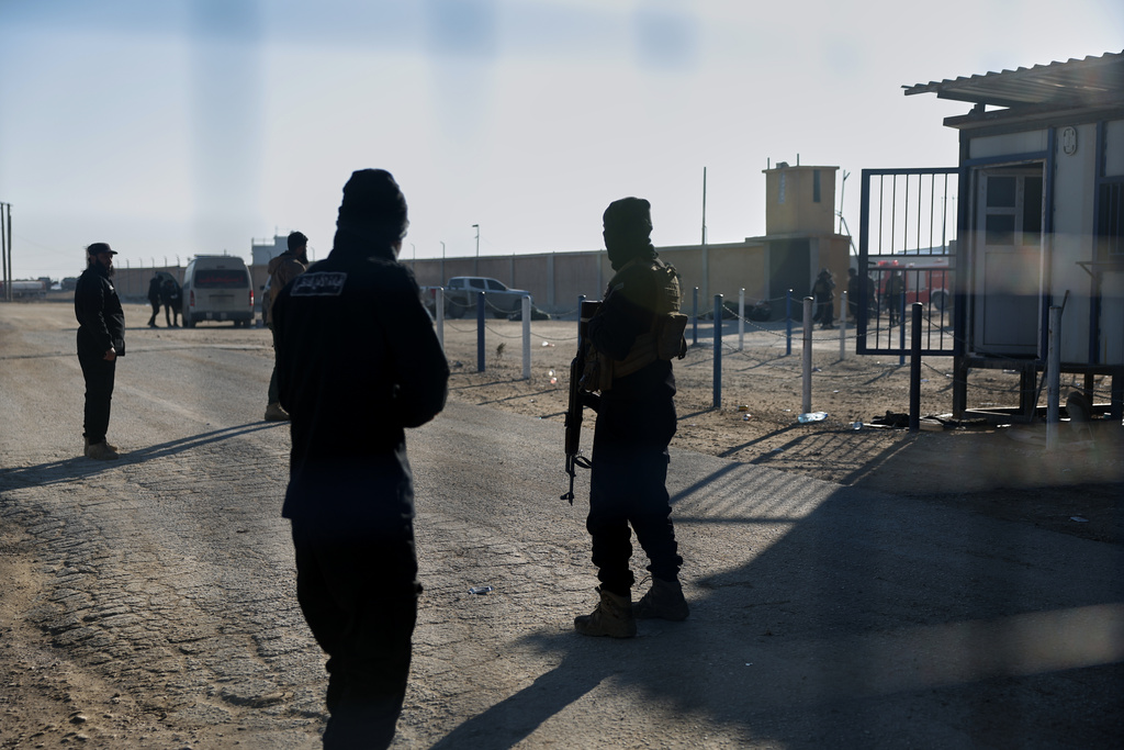 Syrian government troops stand guard at the entrance to the al-Hol camp in northeastern Syria's Hasakeh province, Syria, Wednesday, Jan. 21, 2026, after the withdrawal of the Syrian Democratic Forces (SDF). (AP Photo/Ghaith Alsayed)