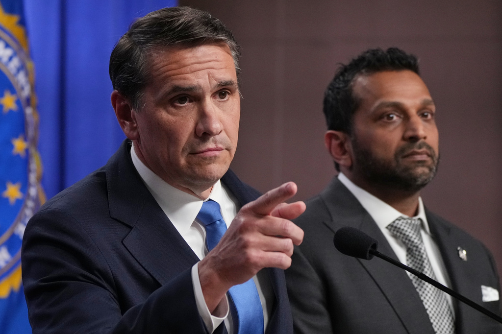 Acting Attorney General Todd Blanche speaks as FBI Director Kash Patel listens during a news conference at the Justice Department, Tuesday, April 21, 2026, in Washington. (AP Photo/Jacquelyn Martin)