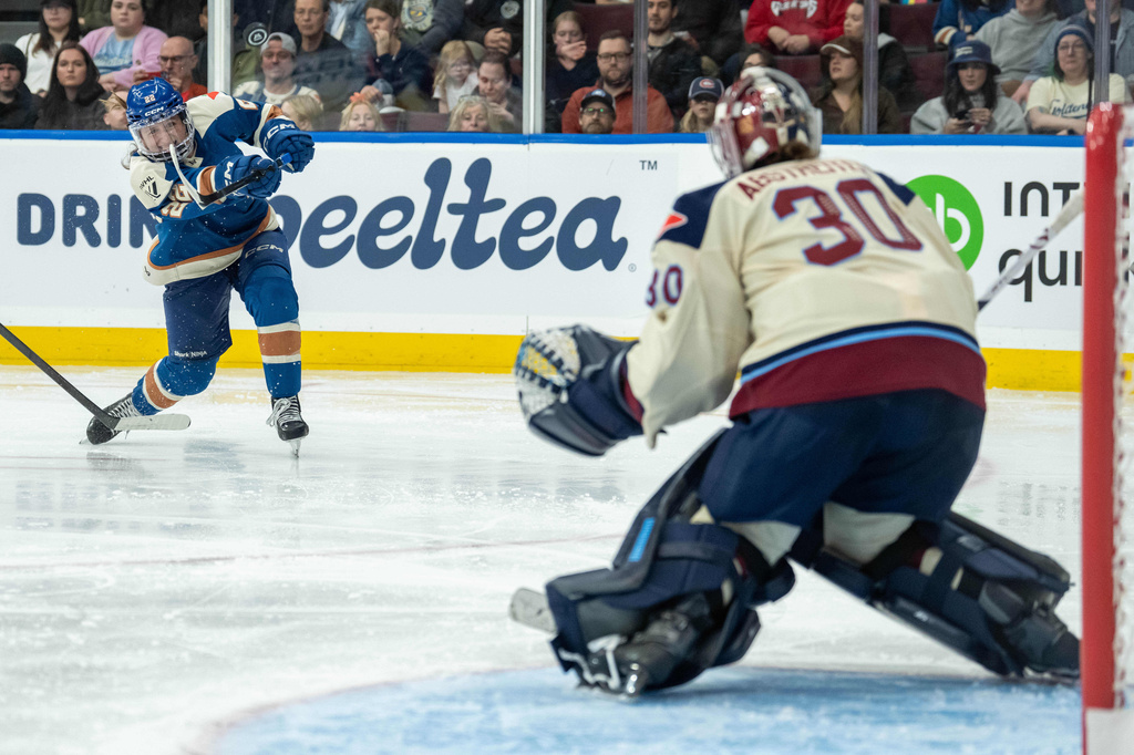 Vancouver Goldeneyes' Abby Boreen (22) shoots the puck as Montreal Victoire goaltender Sandra Abstreiter (30) watches during the third period of a PWHL hockey game, in Vancouver, on Tuesday, April 21, 2026. (Ethan Cairns/The Canadian Press via AP)