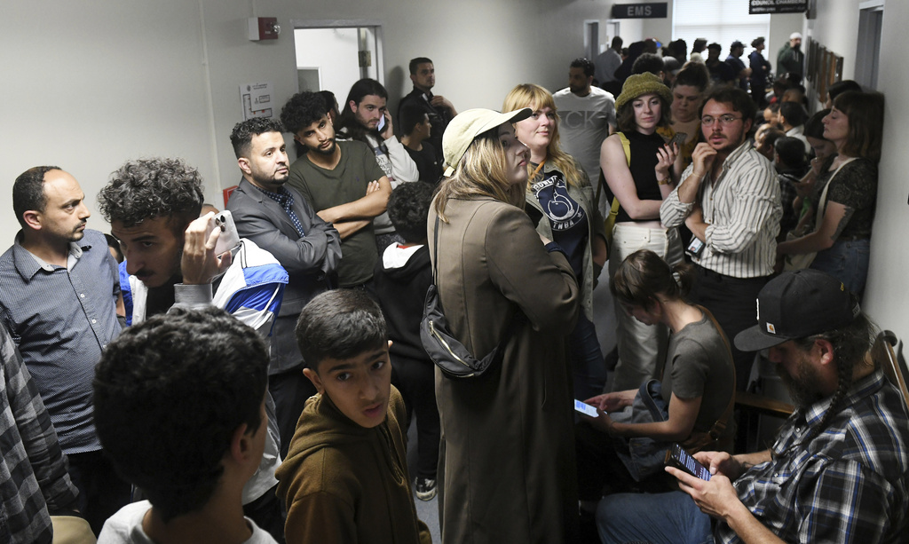 FILE - People who could not get into the Hamtramck city council chambers try to listen via YouTube or on the monitor in the hallway, during public comment on the flag neutrality law being considered by the city council in a meeting at City Hall in Hamtramck, Mich., June 13, 2023. (Robin Buckson/The Detroit News via AP, File)
