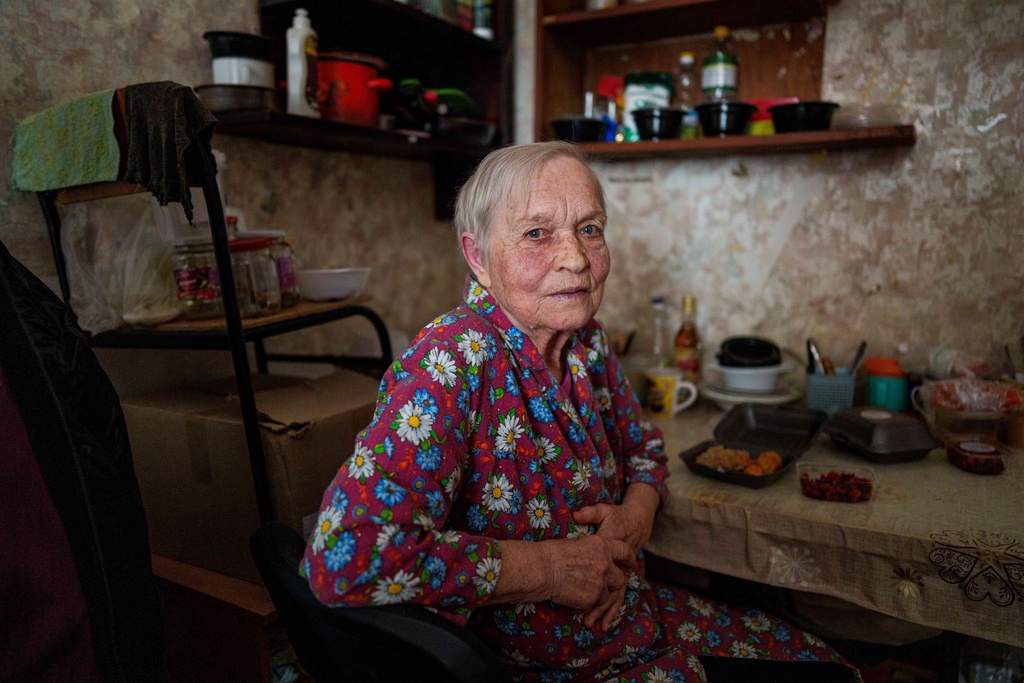 Valentina Khusak, 86, sits in her room at a hostel for displaced persons in Dnipro, Ukraine, Wednesday, Oct. 8, 2025. (AP Photo/Evgeniy Maloletka)