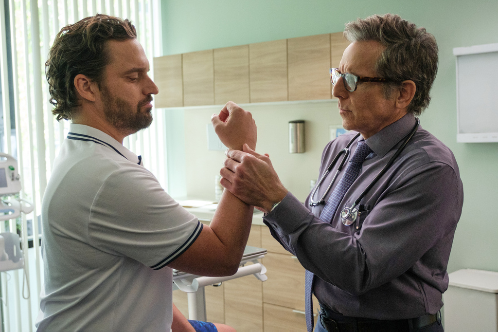This image released by Apple TV shows Jake Johnson, left, and Ben Stiller in a scene from "The DInk." (Andrew Cooper/Apple TV via AP)