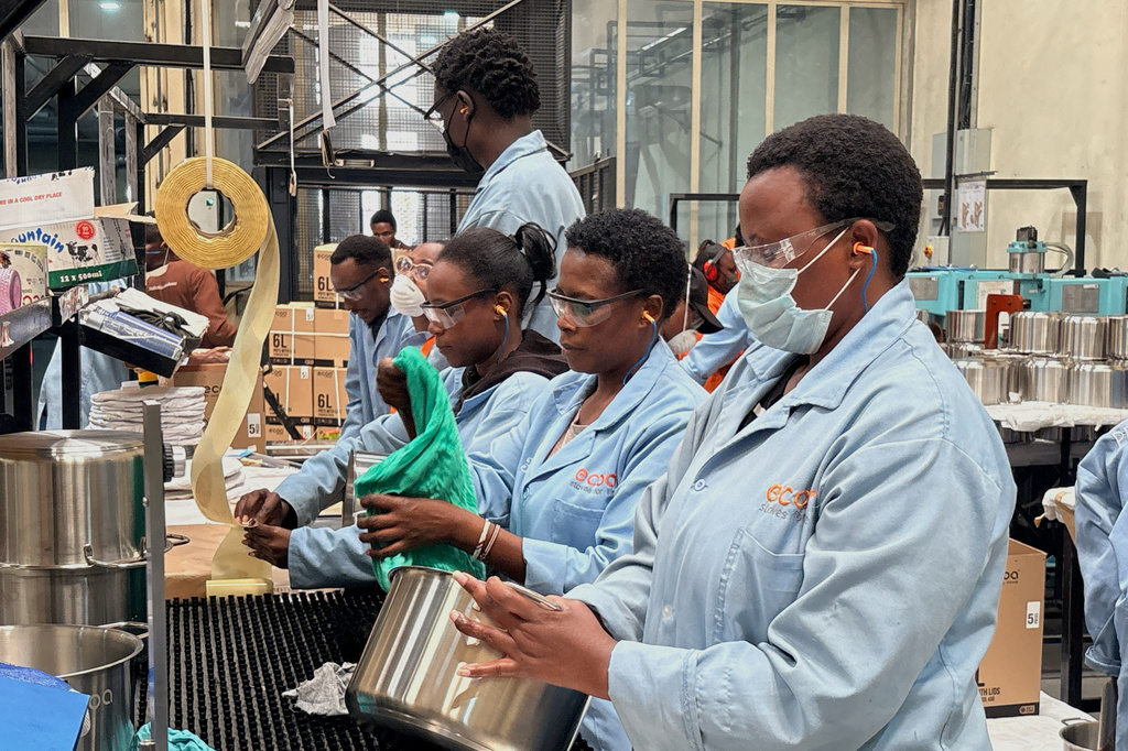 Workers assemble fuel-efficient cookstoves at BURN, a manufacturer of clean cooking appliances, in Kiambu, Kenya, on July 31, 2026. (AP Photo/Allan Olingo)