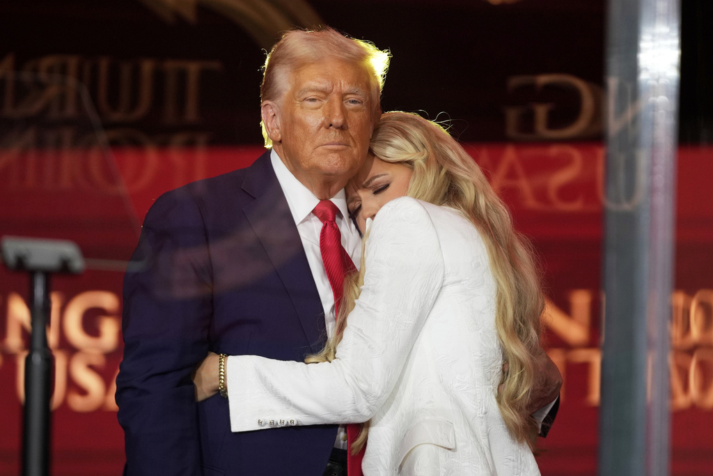 President Donald Trump, left, hugs Erika Kirk at the memorial of her husband, conservative activist Charlie Kirk, Sunday, Sept. 21, 2025, at State Farm Stadium in Glendale, Ariz. (AP Photo/Julia Demaree Nikhinson)