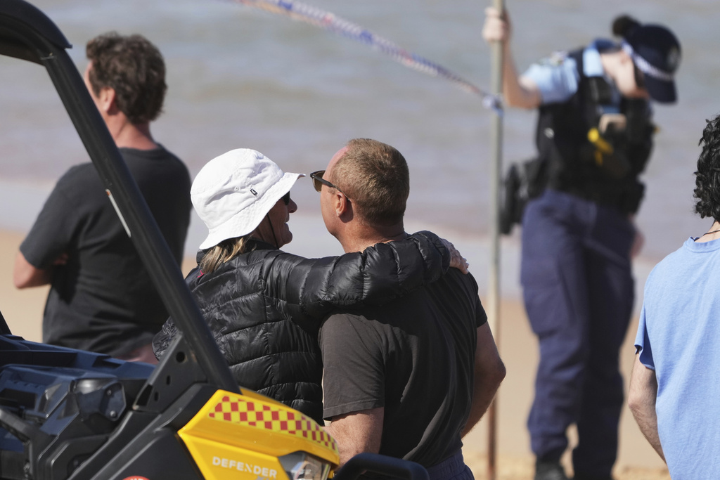 People react at the site of a fatal shark attack at Dee Why Beach in Sydney, Australia, Saturday, Sept. 6, 2025. (AP Photo/Mark Baker)