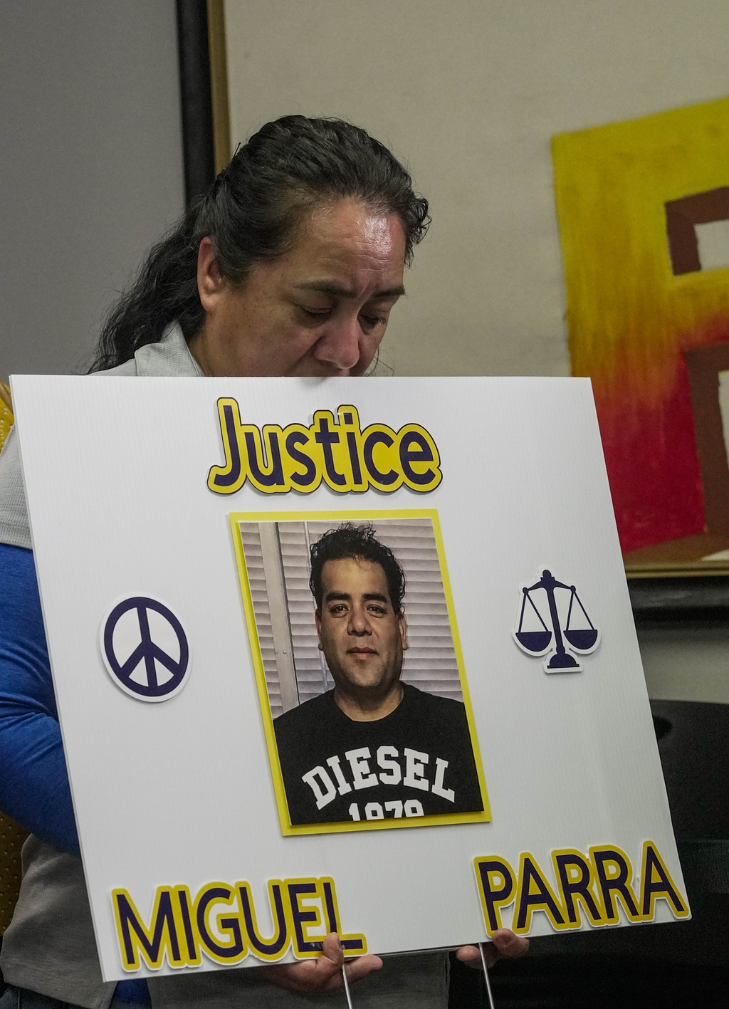 Carmen, sister of Miguel Parra Hernandez, holds a sign during a news conference about the Immigration and Customs Enforcement action involving Hernandez, Wednesday, Oct. 14, 2026, in Houston. (Raquel Natalicchio/Houston Chronicle via AP) Correction corrects first name to Carmen.