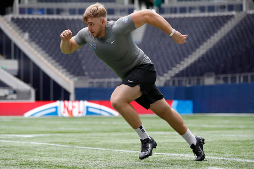 FILE - Offensive lineman Leander Wiegand, of Germany, participates in a drill at the NFL international scouting combine at Tottenham Hotspur Stadium in London, Tuesday, Oct. 4, 2022. (AP Photo/Steve Luciano, File) FILE - Offensive lineman Leander Wiegand, of Germany, participates in a drill at the NFL international scouting combine at Tottenham Hotspur Stadium in London, Tuesday, Oct. 4, 2022. (AP Photo/Steve Luciano, File)