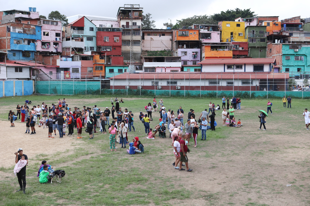 People stand on a park after an earthquake in Caracas, Venezuela, Wednesday, June 24, 2026. (AP Photo/Pedro Mattey)