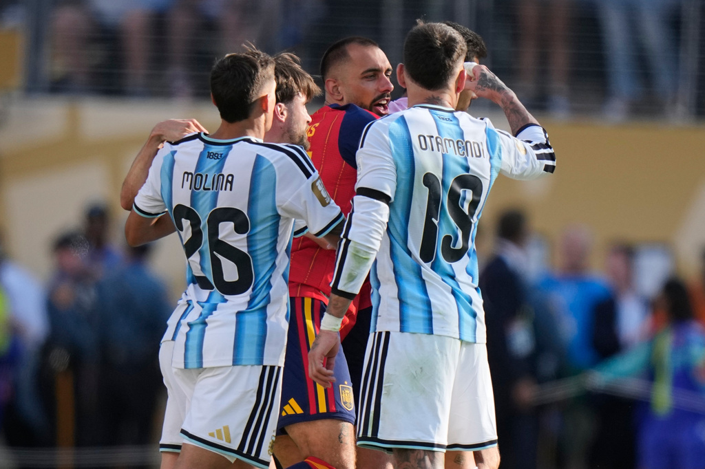 Argentina's Nicolas Otamendi (19) and Nahuel Molina (26) scuffle with a Spain player after the World Cup final soccer match between Spain and Argentina in East Rutherford, N.J., near New York, Sunday, July 19, 2026. (AP Photo/Frank Franklin II)