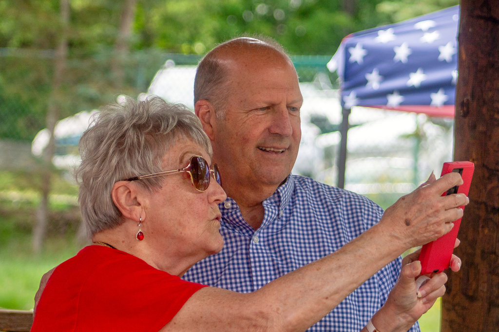 Former Sen. John E. Sununu, who is seeking the GOP nomination for his old seat, takes a selfie with supporter Sudie Francouer, in Berlin, N.H., Saturday, Aug. 22, 2026. (AP Photo/Holly Ramer)