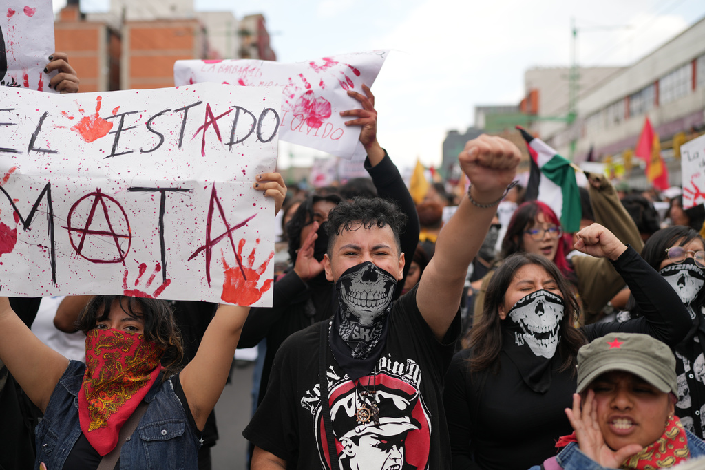 Demonstrators march during a protest commemorating the anniversary of the 1968 Tlatelolco killings, when soldiers fired on student protesters, in Mexico City, Thursday, Oct. 2, 2025. (AP Photo/Eduardo Verdugo)
