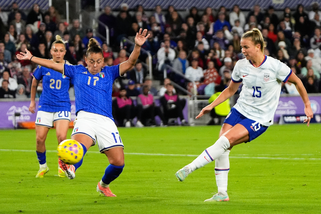 United States midfielder Claire Hutton (15) shoots on goal as Italy defender Lisa Boattin (17) tries to block during the first half of an international friendly soccer match Friday, Nov. 28, 2025, in Orlando, Fla. (AP Photo/John Raoux)