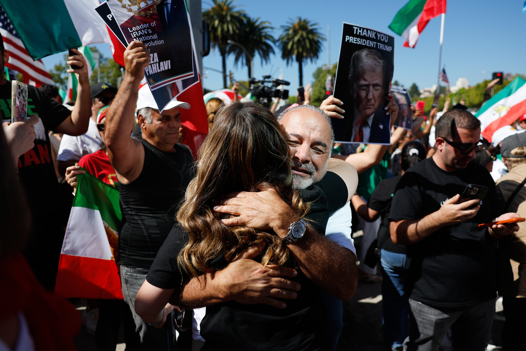 Demonstrators hug as they march in reaction to the U.S. and Israeli strikes on Iran on Saturday, Feb. 28, 2026, in Los Angeles. (AP Photo/Caroline Brehman)