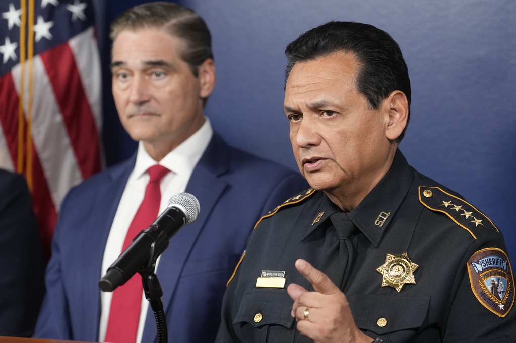 Harris County District Attorney Sean Teare, left, and Harris County Sheriff Ed Gonzalez, right, attend a news conference Friday, Oct. 30, 2026, in Houston, announcing the indictment of U.S. Immigration and Customs Enforcement agent Mario Alberto Morales by a Harris County grand jury. (Melissa Phillip/Houston Chronicle via AP)