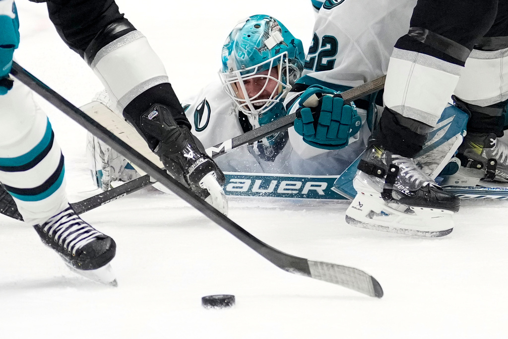 San Jose Sharks goaltender Yaroslav Askarov dives in front of the puck during the second period of an NHL hockey game against the Los Angeles Kings, Wednesday, Jan. 7, 2026, in Los Angeles. (AP Photo/Mark J. Terrill)
