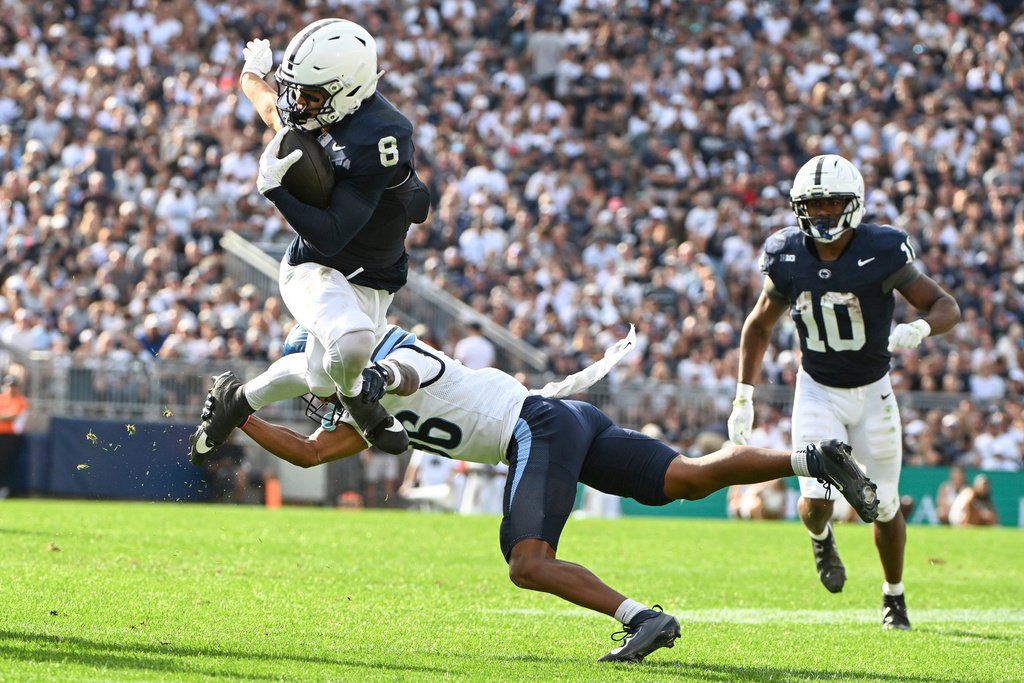 Penn State wide receiver Trebor Pena (8) hurdles Villanova cornerback Damill Bostic Jr., bottom left, during the second quarter of an NCAA college football game, Saturday, Sept. 13, 2025, in State College, Pa. (AP Photo/Barry Reeger)