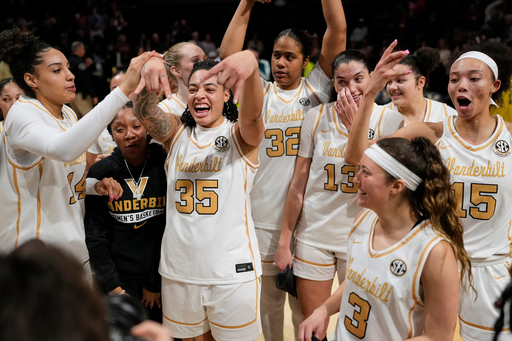 Vanderbilt forward Sacha Washington (35) celebrates the teams win with teammates after an NCAA college basketball game against Texas, Thursday, Feb. 12, 2026, in Nashville, Tenn. (AP Photo/George Walker IV)