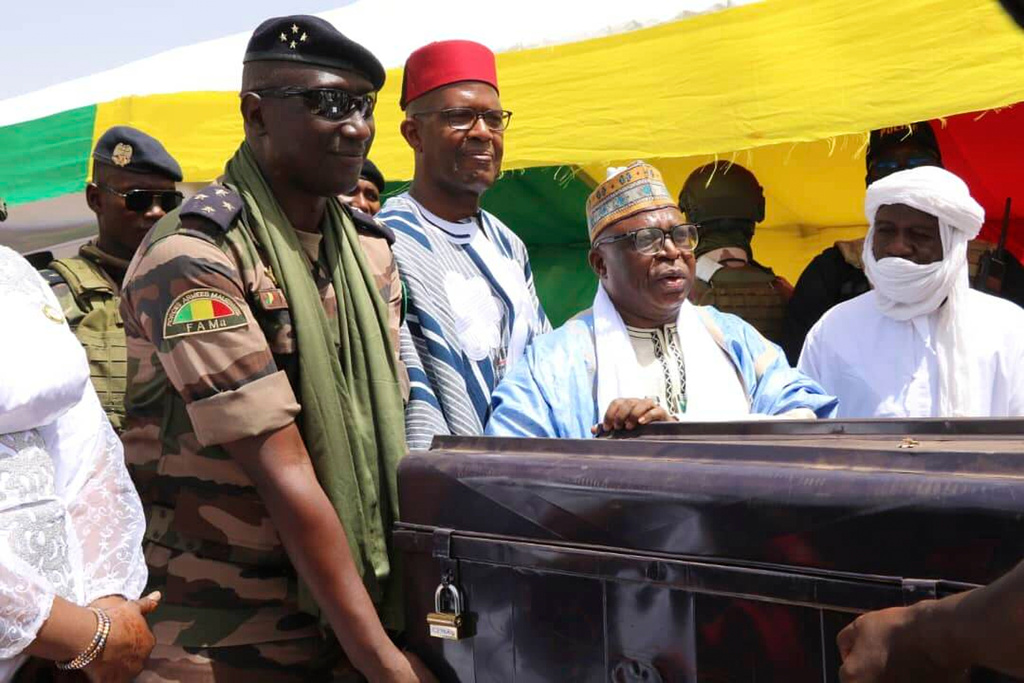 Members of the Malian government return boxes containing ancient Timbuktu manuscripts to the community elders in Timbuktu, Mali, Monday, Aug. 11, 2025. (AP Photo/Moulaye Sayah)