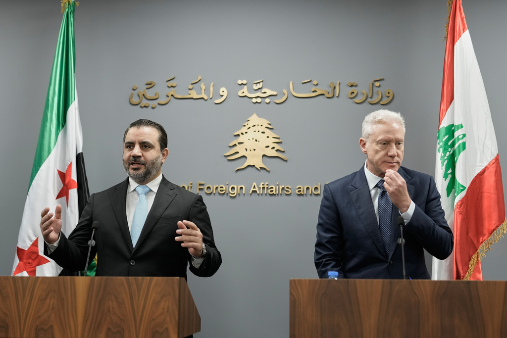 Syrian Foreign Minister Asaad al-Shibani, left, speaks during a briefing for journalists after his meeting with Lebanese Foreign Minister Youssef Rajji, right, in Beirut, Lebanon, Friday, Oct. 10, 2025. (AP Photo/Hassan Ammar)