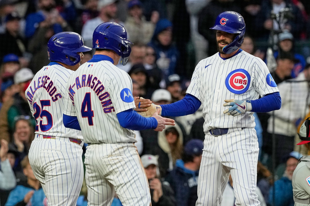 Chicago Cubs' Dansby Swanson, right, celebrates with Moisés Ballesteros, left, and Pete Crow-Armstrong after hitting a three-run home run during the second inning of a baseball game against the Philadelphia Phillies, in Chicago, Monday, April 20, 2026. (AP Photo/Nam Y. Huh)