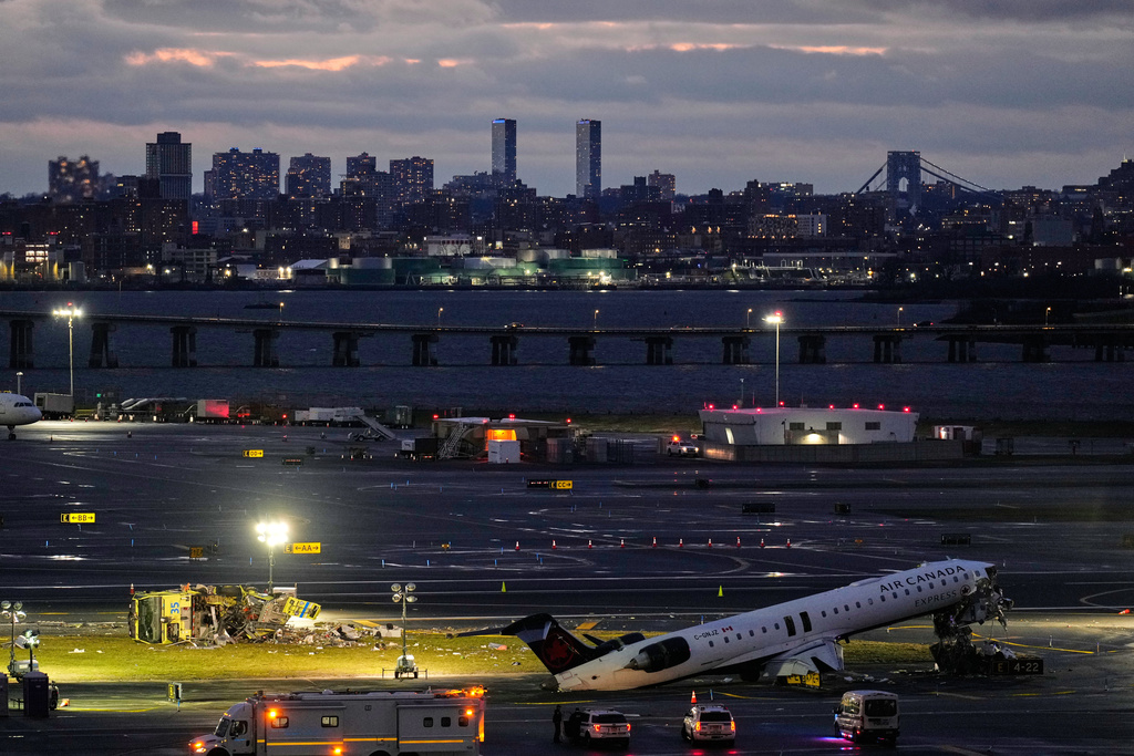 An Air Canada jet and Port Authority fire truck sit on the runway at LaGuardia Airport, Monday, March 23, 2026, after colliding with each other after the jet landed Sunday night in New York. (AP Photo/Seth Wenig)