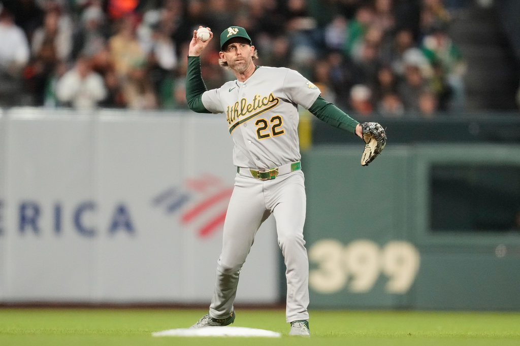 Athletics second baseman Jeff McNeil (22) throws out San Francisco Giants' Casey Schmitt at first base during the sixth inning of a baseball game Wednesday, June 24, 2026, in San Francisco. (AP Photo/Jeff Chiu)