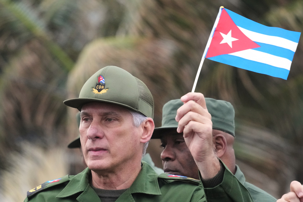 Cuban President Miguel Diaz-Canel marches during a rally to protest the killing of Cuban officers during the U.S. operation in Venezuela that captured Venezuelan President Nicolas Maduro outside the U.S. Embassy in Havana, Cuba, Friday, Jan. 16, 2026. (AP Photo/Ramon Espinosa)