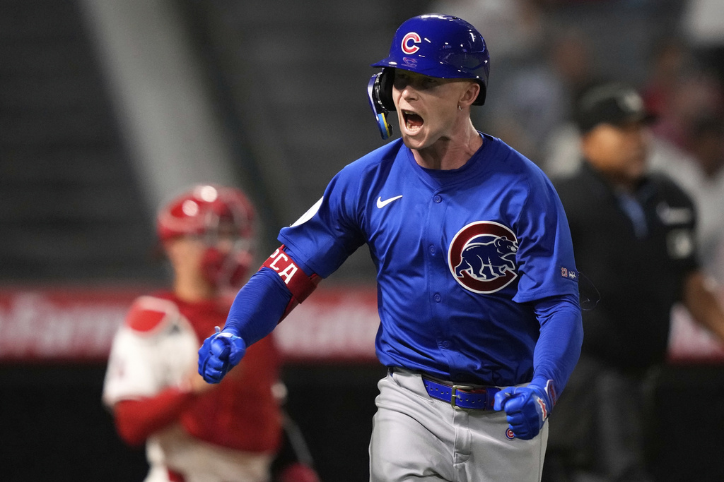 Chicago Cubs' Pete Crow-Armstrong, right, celebrates toward his dugout after hitting a solo home run as Los Angeles Angels catcher Logan O'Hoppe, left, kneels at the plate during the XX inning of a baseball game Friday, Aug. 22, 2025, in Anaheim, Calif. (AP Photo/Mark J. Terrill)