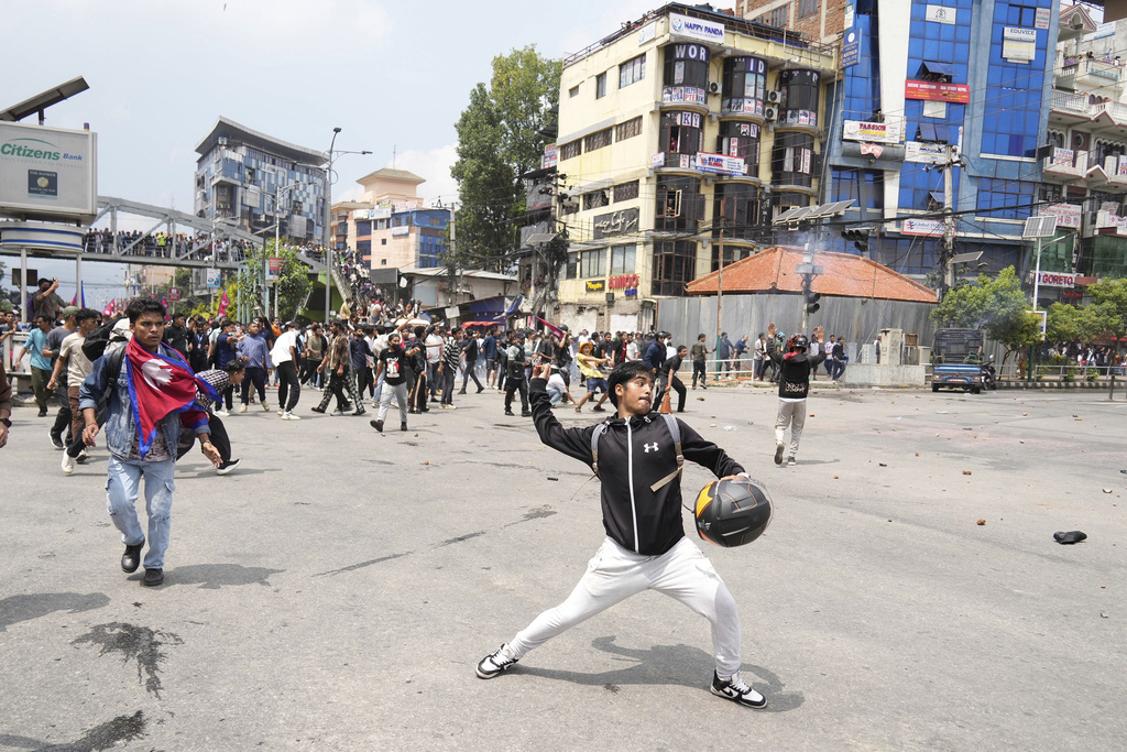 Protestors clash with the riot police outside the Parliament building in Kathmandu, Nepal, Monday, Sept. 8, 2025. (AP Photo/Niranjan Shrestha)