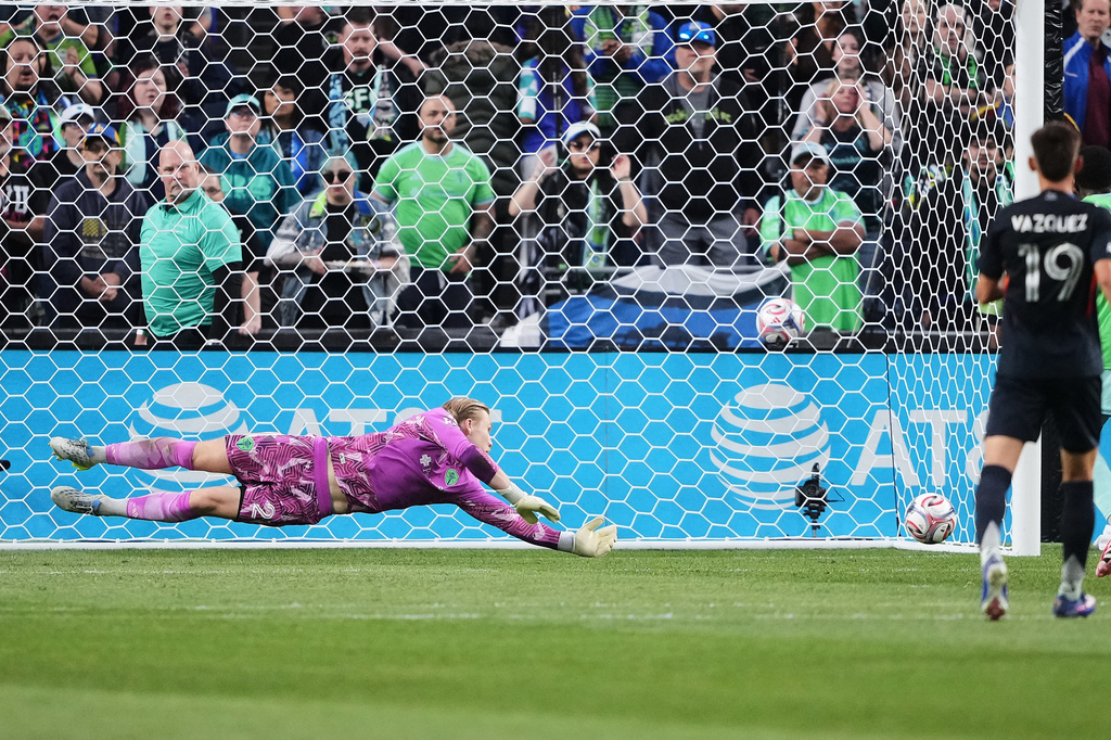 Seattle Sounders goalkeeper Andrew Thomas dives to keep a San Diego FC shot out of the goal during the first half of an MLS soccer match, Saturday, May 9, 2026, in Seattle. (AP Photo/Lindsey Wasson)