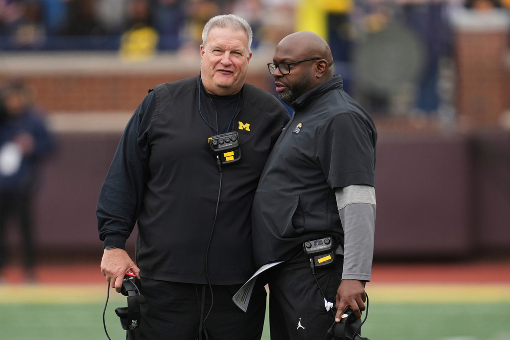 FILE - Michigan associate head coach Biff Poggi, left, talks with running backs coach Tony Alford talk during an NCAA college football spring game in Ann Arbor, Mich., Saturday, April 19, 2025. (AP Photo/Paul Sancya, File)