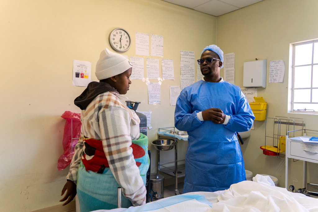 Male midwife Sehloho Ntlhane consults with expectant mother Bonolo Tebelo during an prenatal appointment at Mpharane Health Centre in Mohale's Hoek district, Lesotho, Friday, July 10, 2026. (AP Photo/Kayleen Morgan)