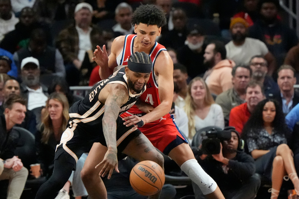 Atlanta Hawks guard Nickeil Alexander-Walker (7) drives against Los Angeles Clippers guard Kobe Sanders (4) during the first half of an NBA basketball game, Wednesday, Dec. 3, 2025, in Atlanta. (AP Photo/Mike Stewart)