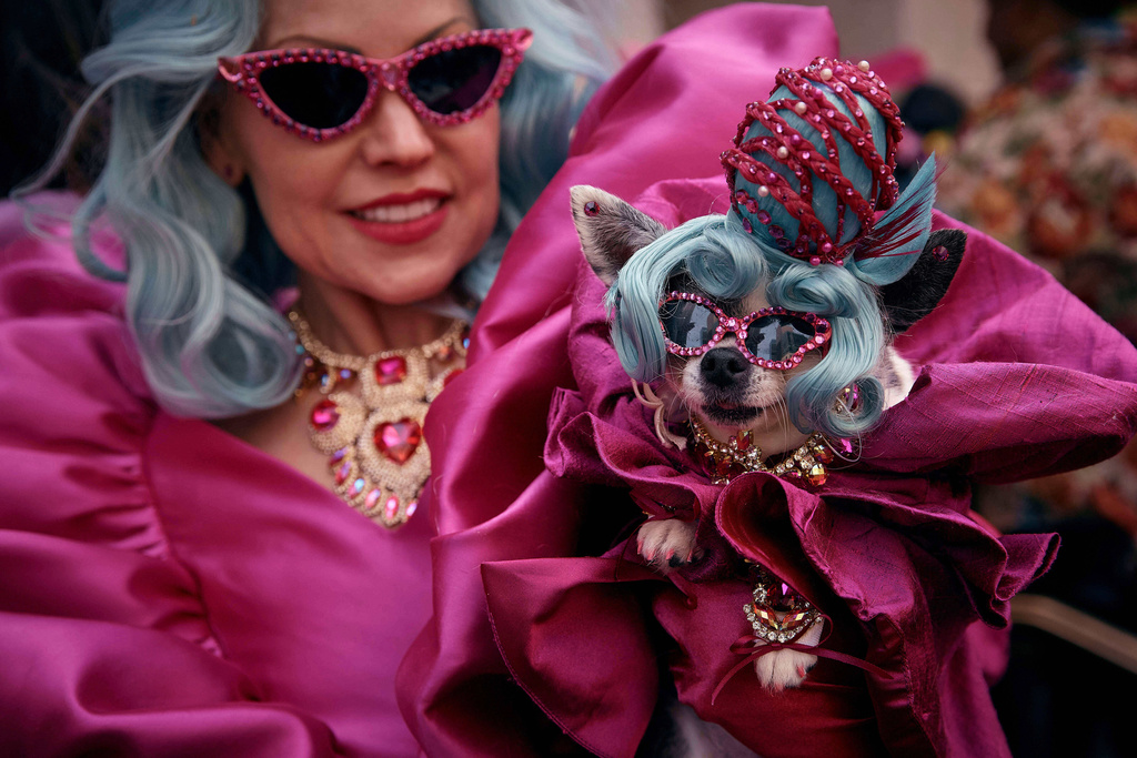 A reveler holds her dog as she participates in the annual Easter Parade and Bonnet Festival in front of St. Patrick's Cathedral, in New York, April 20, 2025. (AP Photo/Andres Kudacki, File)