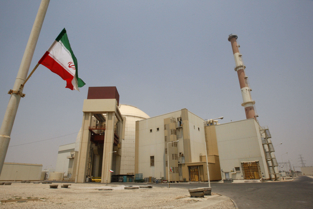 FILE -An Iranian flag flutters in front of the reactor building of the Bushehr nuclear power plant, just outside the southern city of Bushehr, Iran, Saturday, Aug. 21, 2010. (AP Photo/Vahid Salemi, File)