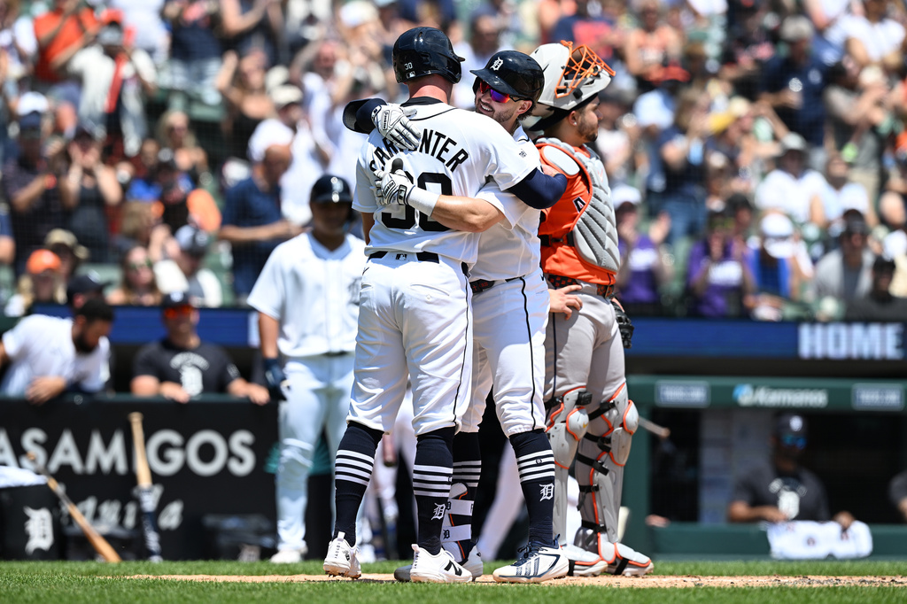 Detroit Tigers' Zach McKinstry, center, celebrates with teammate Kerry Carpenter, left, at home after hitting a two-run home run against the Houston Astros in the second inning of a baseball game, Sunday, June 28, 2026, in Detroit. (AP Photo/Lon Horwedel)