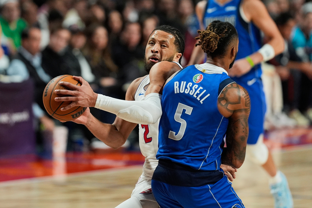 Dallas Mavericks guard D'Angelo Russell challenges Detroit Pistons guard Cade Cunningham during the first half of an NBA basketball game in Mexico City, Saturday, Nov. 1, 2025. (AP Photo/Fernando Llano)