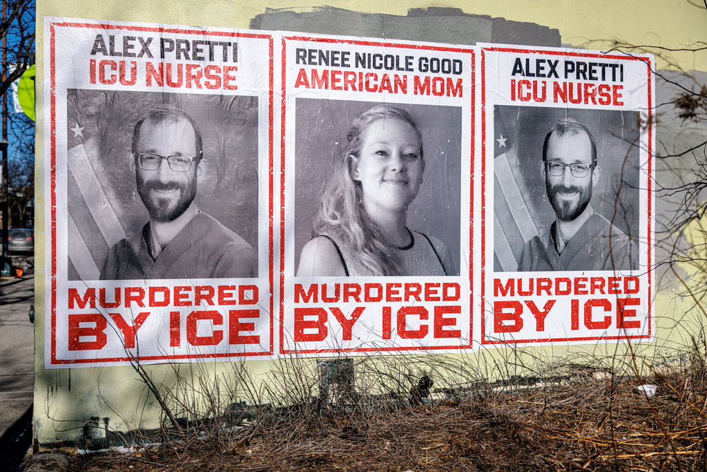 Posters depicting Alex Pretti and Renee Nicole Good are displayed on a wall near the site where Pretti, a 37-year-old ICU nurse, was fatally shot by federal immigration agents, in Minneapolis, Minn., Thursday, Jan. 29, 2026. (Kerem Yücel/Minnesota Public Radio via AP)