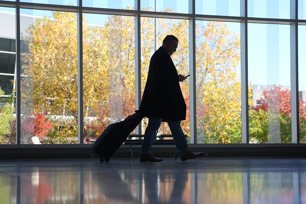 A traveler moves through a baggage claim in Philadelphia International Airport in Philadelphia, Wednesday, Nov. 5, 2025. (AP Photo/Matt Rourke)