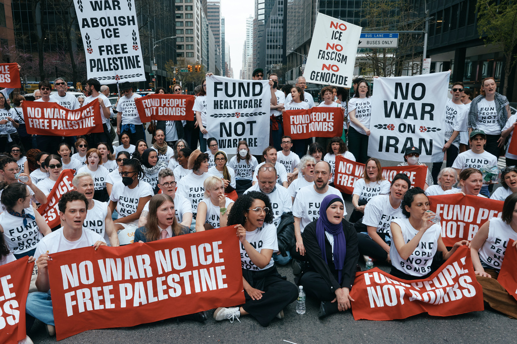 Chelsea Manning, bottom second left, and protesters with Jewish Voice for Peace block traffic during a demonstration outside the New York office of U.S. Sen. Chuck Schumer, calling for an end to the U.S.-Israel war with Iran and opposing U.S. weapons support, Monday, April 13, 2026, in New York. (AP Photo/Andres Kudacki)