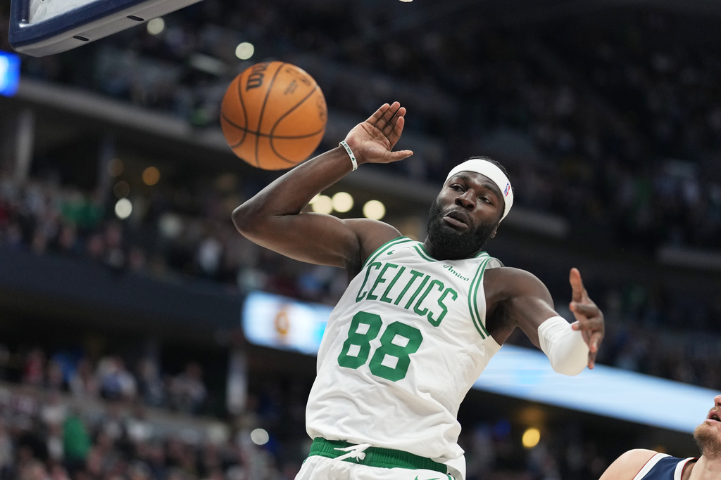 Boston Celtics center Neemias Queta reacts after dunking the ball for a basket in the first half of an NBA basketball game against the Denver Nuggets Wednesday, Feb. 25, 2026, in Denver. (AP Photo/David Zalubowski)