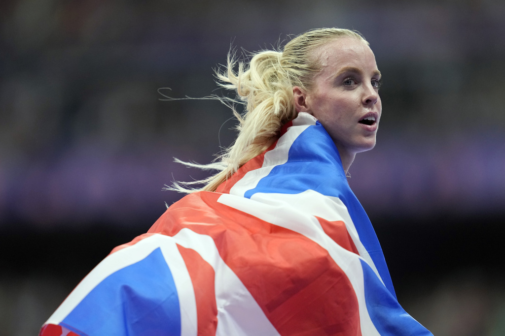 FILE - Keely Hodgkinson, of Britain, celebrates after winning the gold medal in the women's 800 meters final at the 2024 Summer Olympics, Aug. 5, 2024, in Saint-Denis, France. (AP Photo/Ashley Landis, File)